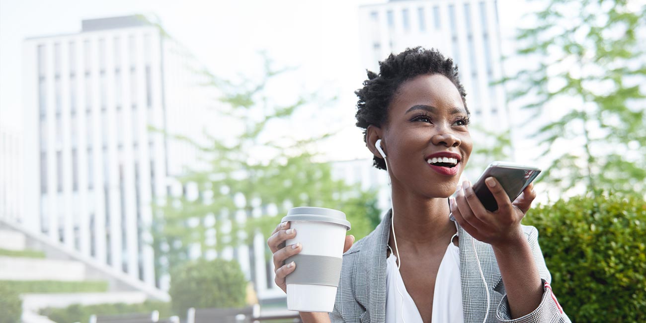 Smiling businesswoman on phone at sidewalk cafe